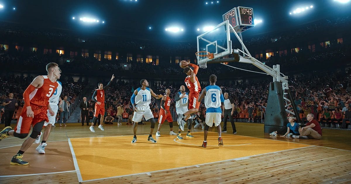 a basketball player dunking a ball in a basketball court